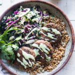 Vegan Lentil Patties made with walnuts and mushrooms topped with flavorful Zhoug yogurt.