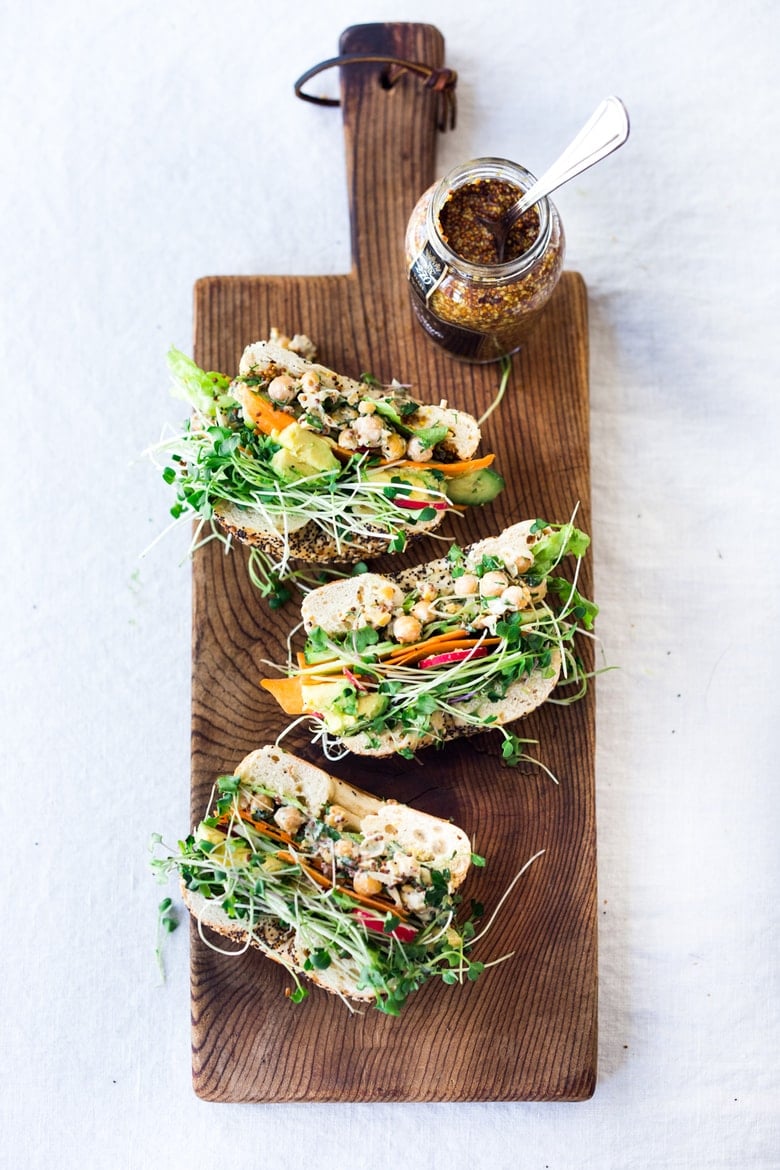 Vegan Green Goddess Sandwich with herby chickpea salad, crunchy carrots & radishes, cucumber, avocado and sprouts. Vegan and Gluten-free adaptable!