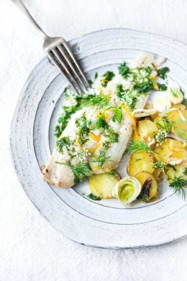 Sheet Pan Dover Sole with Potatoes, leeks, Lemon & Dill Oil- a simple healthy dinner that can be made in 25 minutes. #dill #sole #dillsauce #fishrecipe #healthyfish