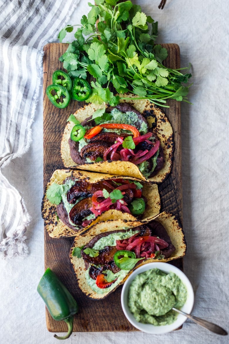 Chipotle Portobello Tacos on a wood board with Vegan Cilantro Crema 