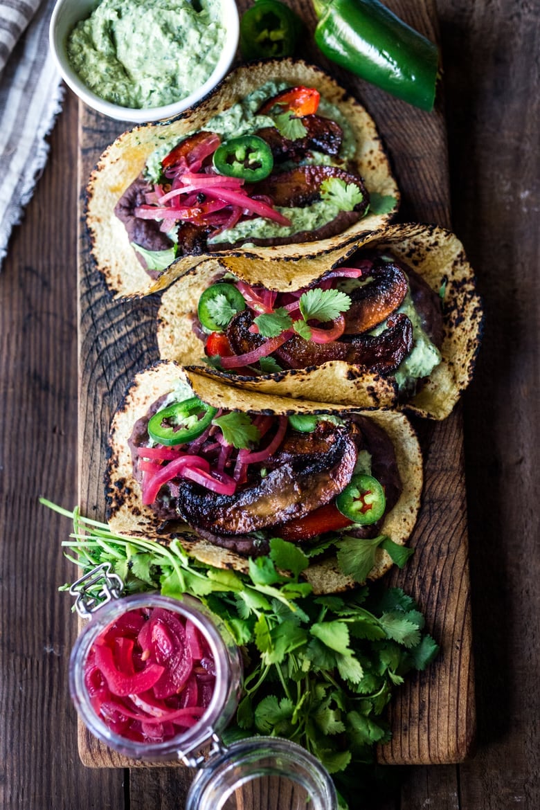 Chipotle Portobello Tacos on a wood board with Vegan Cilantro Crema 