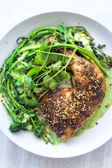 This Za'atar Chicken recipe pairs juicy, crispy chicken thighs with roasted broccolini and a vibrant green tahini sauce for an easy, flavor-packed Middle Eastern-inspired dinner.