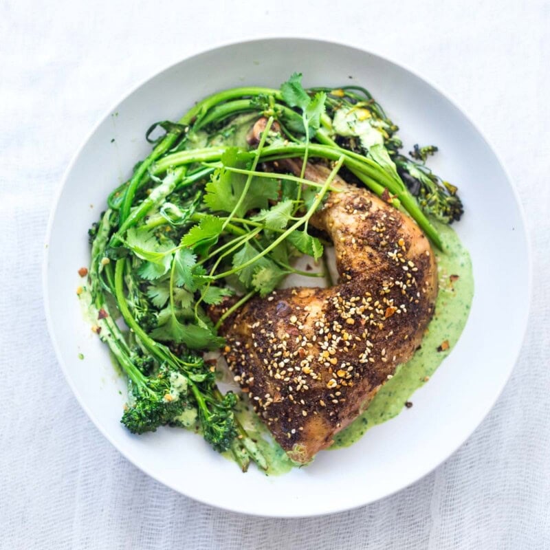 This Za'atar Chicken recipe pairs juicy, crispy chicken thighs with roasted broccolini and a vibrant green tahini sauce for an easy, flavor-packed Middle Eastern-inspired dinner.