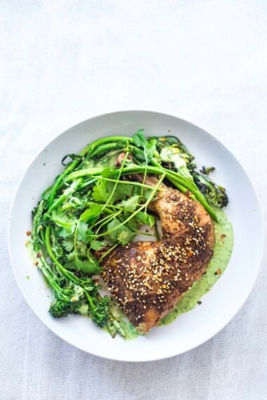 This Za'atar Chicken recipe pairs juicy, crispy chicken thighs with roasted broccolini and a vibrant green tahini sauce for an easy, flavor-packed Middle Eastern-inspired dinner.