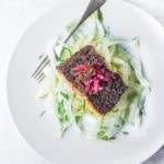 Chia Crusted Salmon, served over cool crunchy fennel slaw, topped with quick pickled onions. A simple, elegant dinner that is quick and healthy. #salmon #fennel #chia #fennelslaw #fennelsalad