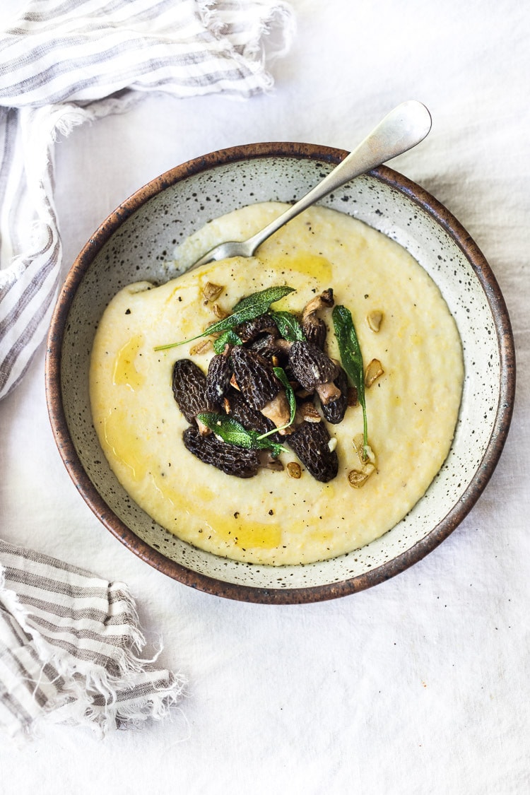 Creamy Polenta with Wild Mushrooms, Garlic and Sage. A simple EASY dinner that can be made in under 30 minutes. Comfort food that is healthy, vegan adaptable and gluten-free! | #polenta #creamypolenta #mushrooms #morels #chanterelles #mushroompolenta #polenta #vegan