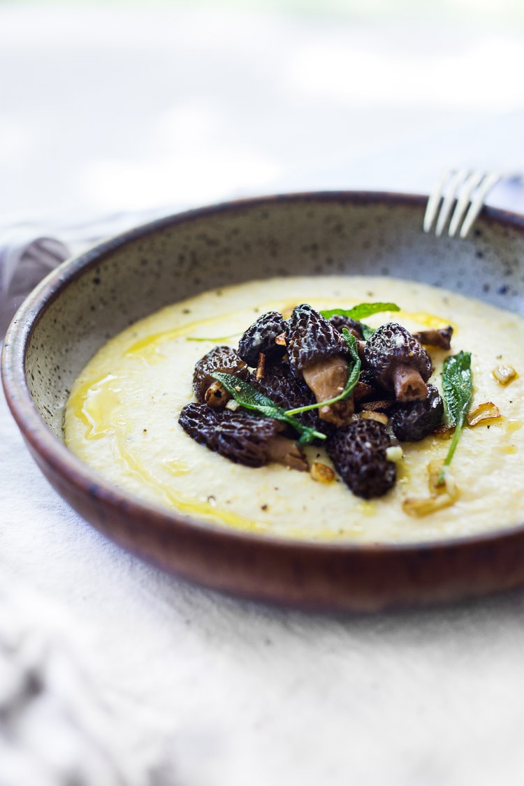 Creamy Polenta with Wild Mushrooms, Garlic and Sage. A simple EASY dinner that can be made in under 30 minutes. Comfort food that is vegetarian and gluten-free! | #polenta #creamypolenta #mushrooms #morels #chanterelles