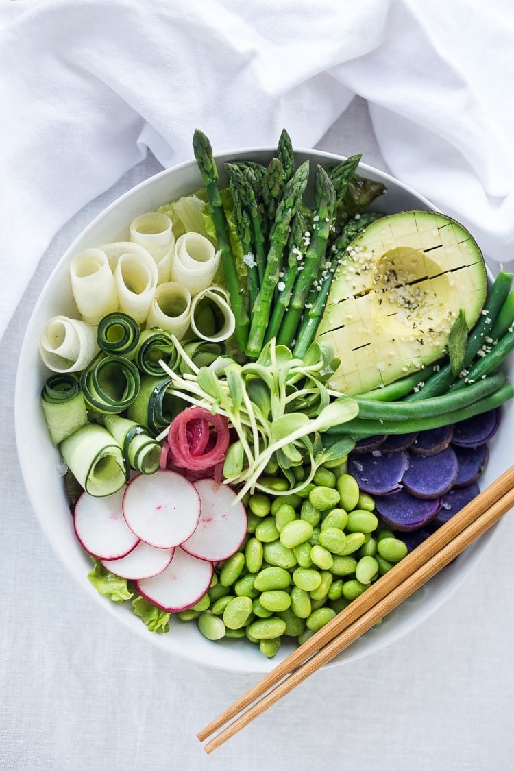  Green Goddess Bowl featuring the best of fresh spring produce arranged beautifully over a bed of greens or grains, and topped with a creamy vegan green goddess dressing. 