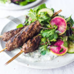 Grilled Lamb Kebabs with a tangy Herb Salad and Dilled Yogurt Sauce- a delicious, paleo friendly recipe featuring Middle Eastern flavors.