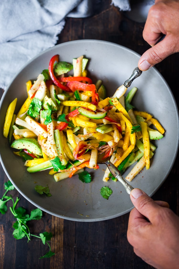 Jicama Salad with Mango, Cucumber, Avocado, Lime and Aleppo Chile Flakes - a delicious healthy side dish that pairs well with grilled chicken and fish. Perfect for alfresco dining, outdoor gatherings, barbecues and potlucks!  #potluck #mangosalad #jicamasalad #potluckideas #vegan #jicama