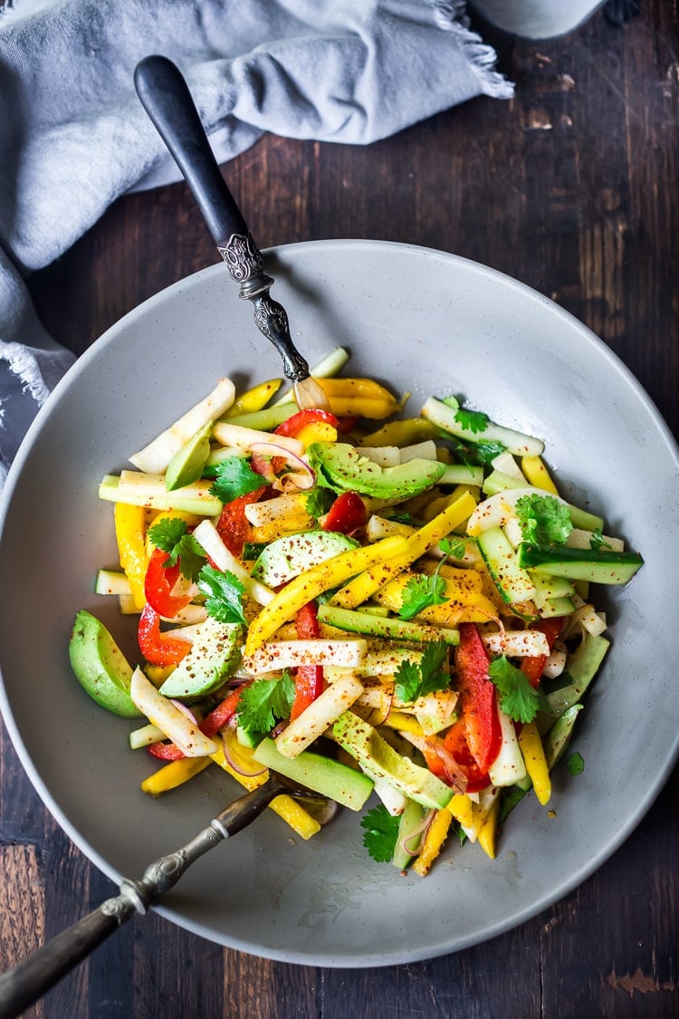 Jicama Salad with Mango, Cucumber, Avocado, Lime and Aleppo Chile Flakes - a delicious healthy side dish that pairs well with grilled chicken and fish. Perfect for alfresco dining, outdoor gatherings, barbecues and potlucks!  #potluck #mangosalad #jicamasalad #potluckideas #vegan #jicama