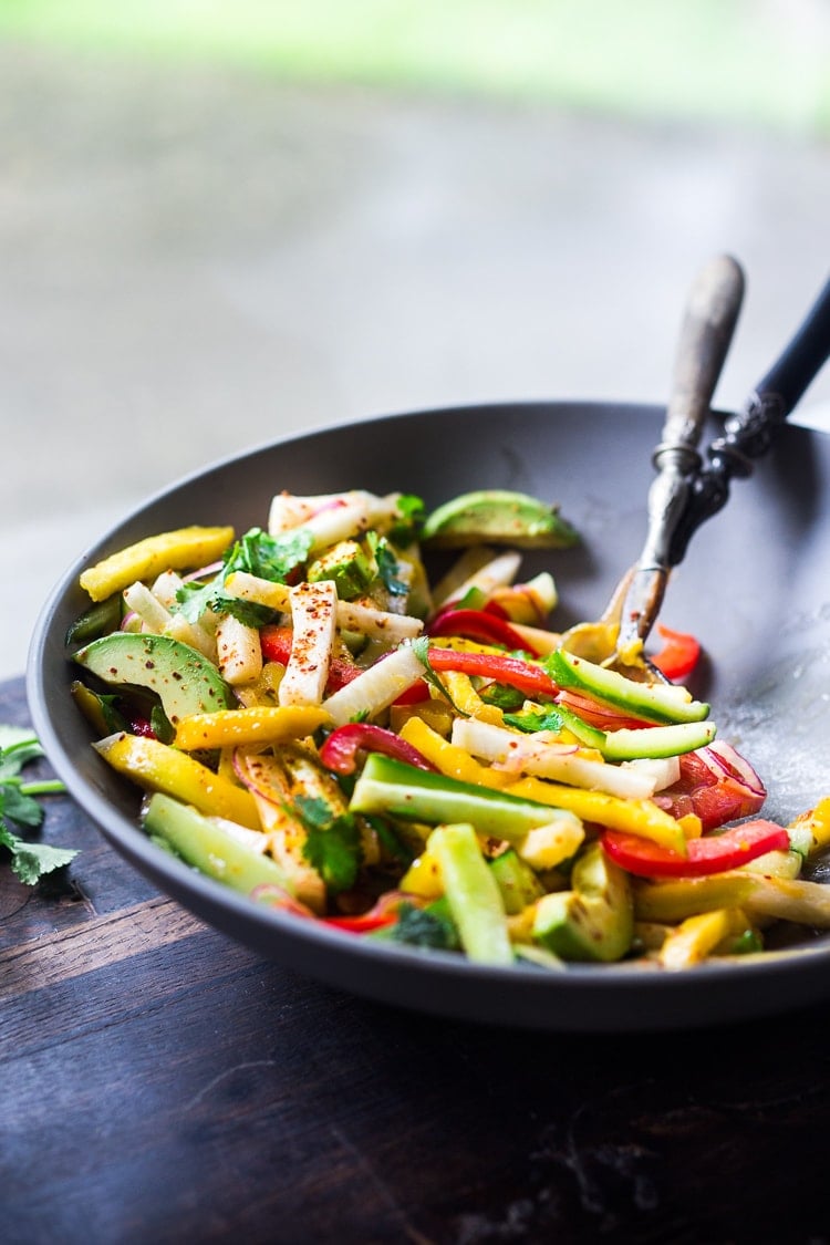 Jicama Salad with Mango, Cucumber, Avocado, Lime and Aleppo Chile Flakes - a delicious healthy side dish that pairs well with grilled chicken and fish. Perfect for alfresco dining, outdoor gatherings, barbecues and potlucks!  #potluck #mangosalad #jicamasalad #potluckideas #vegan #jicama