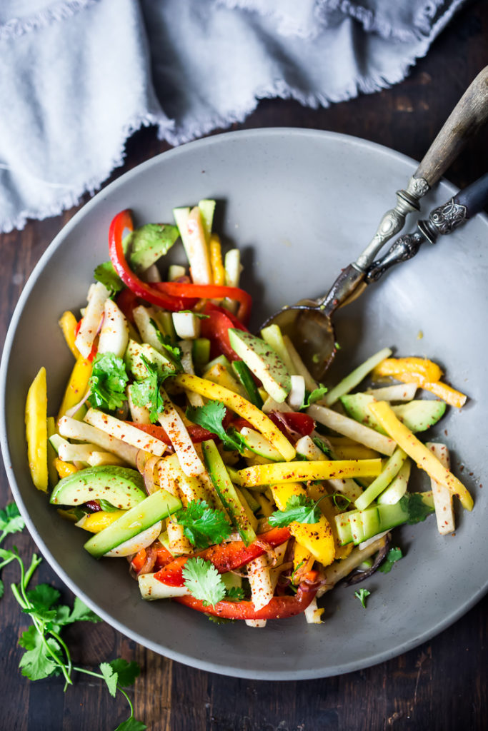 Jicama Salad with cucumber and mango in a grey bowl.