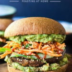 Japanese-style, grilled, vegan portobello mushroom burger is full of delicious umami flavor! It's lathered with Japanese "Guacamole", topped with a cool cucumber ribbon salad and crunchy carrot slaw. Healthy, delicious and really satisfying. AND totally vegan! #veganburger #portobelloburger #veganportobelloburger #portobellomushroomrecipes #portobello #vegan #veganburger #grilled #grilledportobello