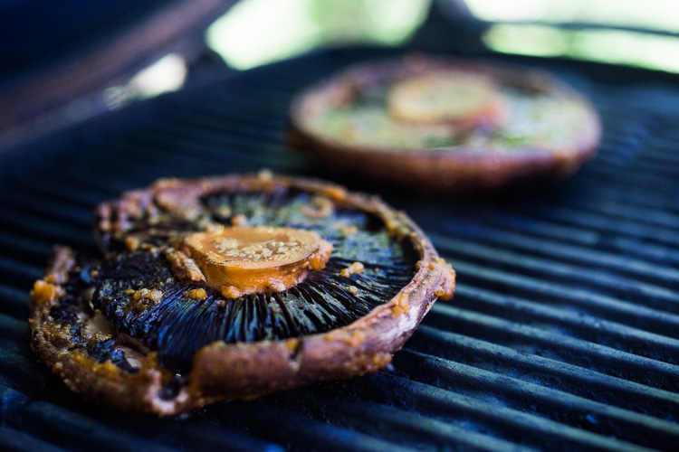 portobello mushrooms, gills-side up, grilling with marinade brushed over top.