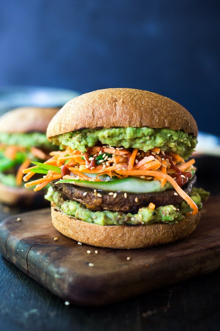 40 Mouthwatering Vegan Dinner Recipes!|This Asian-style, grilled, vegan portobello mushroom burger is full of delicious umami flavor! It's lathered with Asian-style Guacamole, topped with a cool cucumber ribbon salad and crunchy carrot slaw. Healthy, delicious and really satisfying. AND totally vegan! #veganburger #portobelloburger #veganportobelloburger #portobellomushroomrecipes #portobello #vegan #veganburger #grilled #grilledportobello