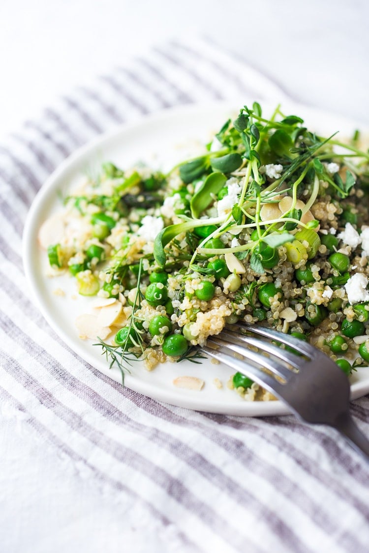 A simple recipe for Quinoa Asparagus Salad ( aka Spring Tabouli) tossed with English peas,  fresh dill, parsley, toasted almonds in a lemony dressing topped with optional avocado, goat or feta cheese. A healthy, flavorful salad that can be made ahead- perfect for special gatherings or midweek lunches! GF &  Vegan adaptable! 