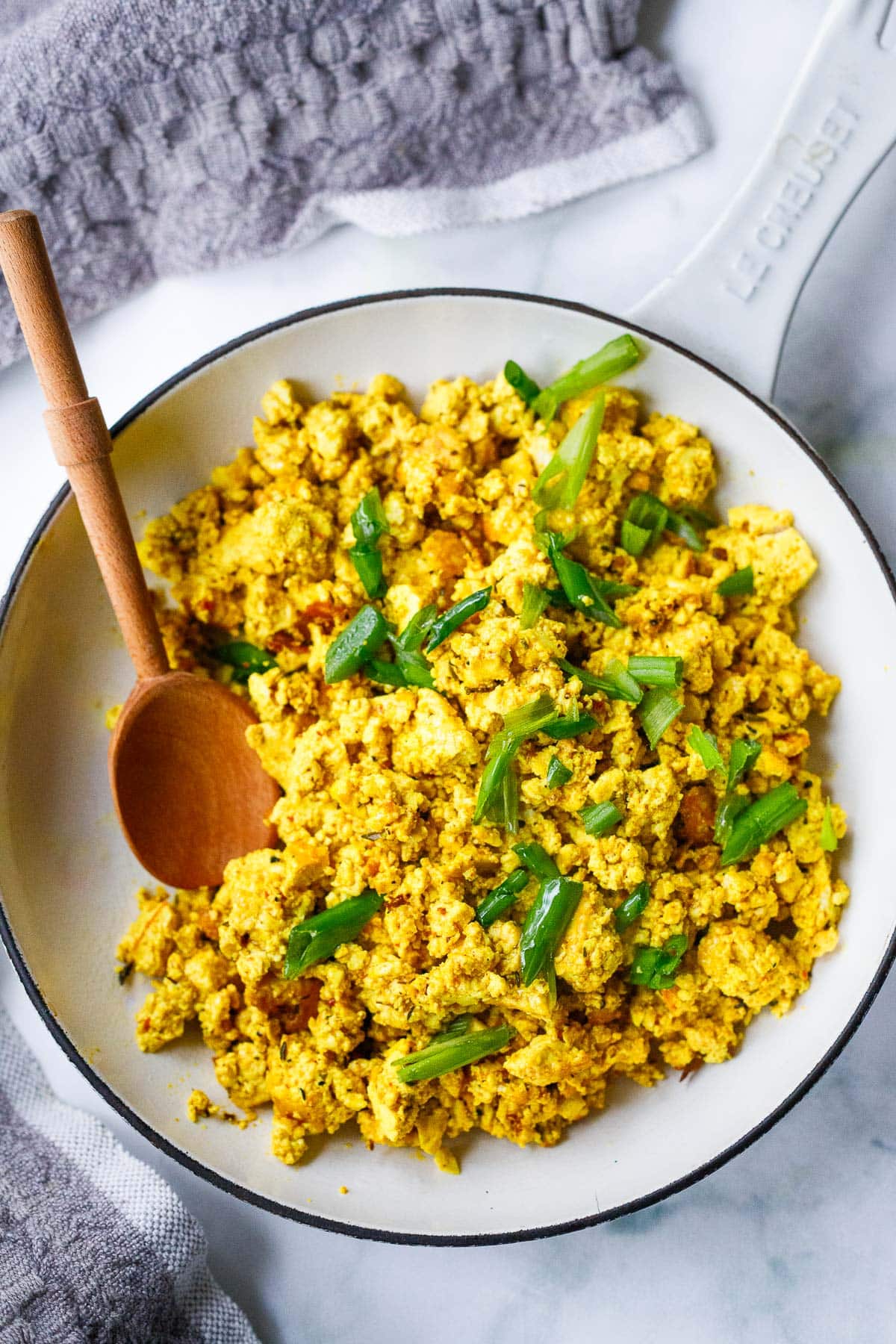 This Tofu Scramble recipe is so delicious! Load it up with seasonal veggies that you already have on hand, or keep it plain and simple- either way, you'll love this high-protein vegan breakfast. Make it in 15 minutes!