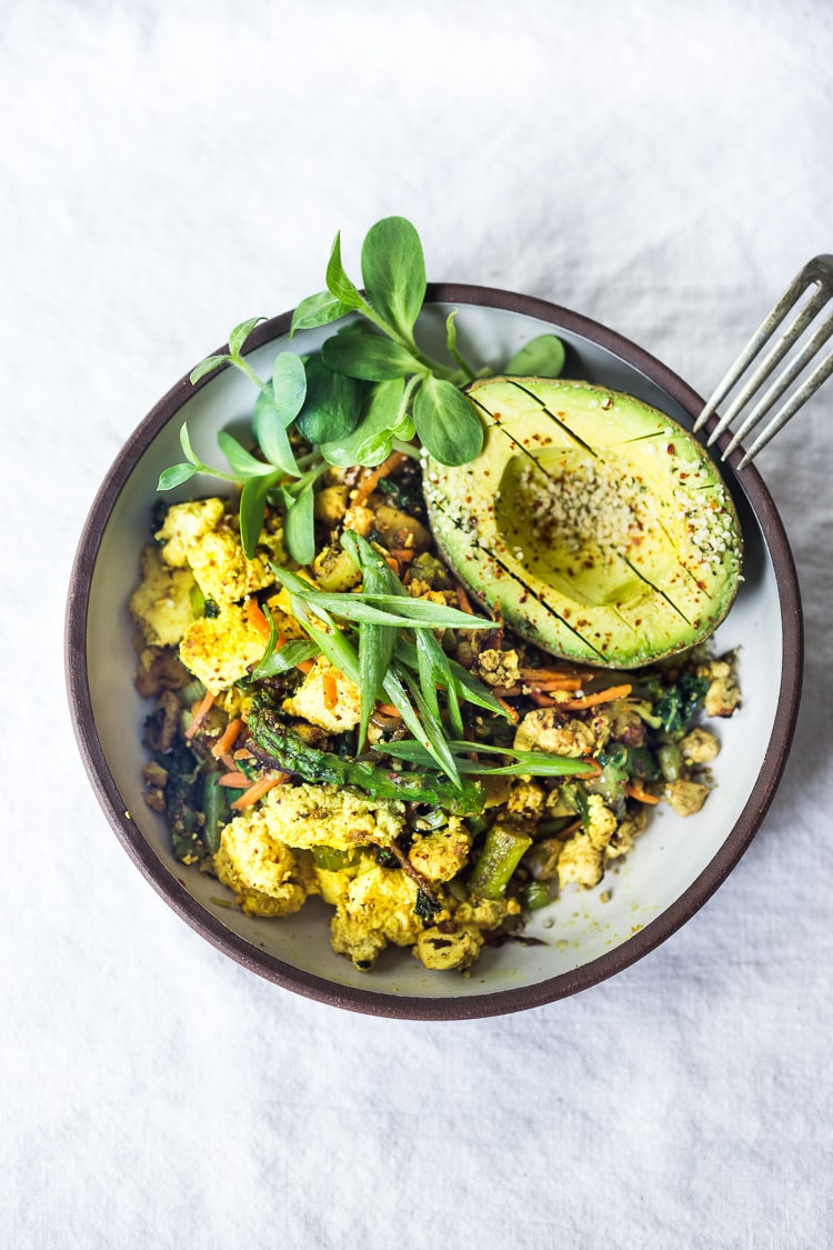 Vegan Tofu Scramble - loaded up with healthy seasonal veggies that you already have on hand. This vegan breakfast can be made in 15 minutes flat! Healthy, Fast, delicious! #vegan #veganbreakfast #tofuscramble #plantbased #eatclean #cleaneating #cleaneats 