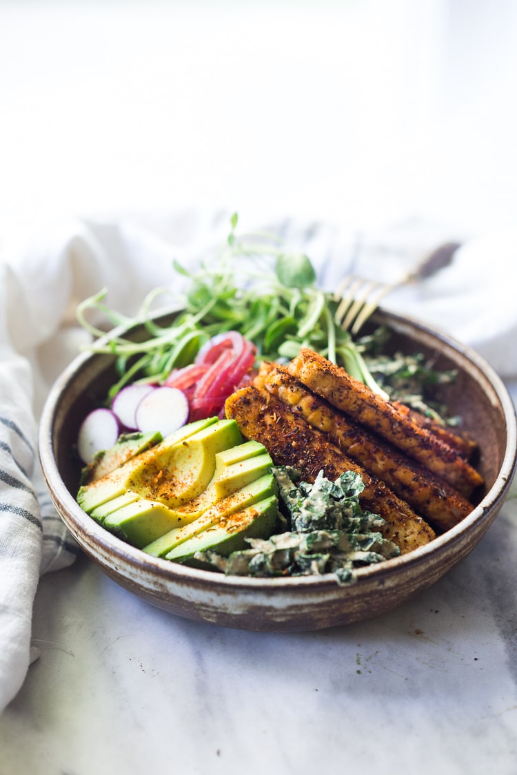 This Blackened Tempeh Kale Salad with avocado, radishes, and pickled onions is tossed in the most flavorful creamy VEGAN Cajun Ranch Dressing! Serve it as a  salad or turn it into a hearty wrap. 