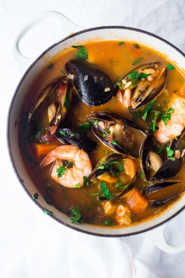 This Cioppino recipe is easy to make and full of rich flavor! Fresh fish and seafood is bathed in a light, fragrant tomato broth. Video.