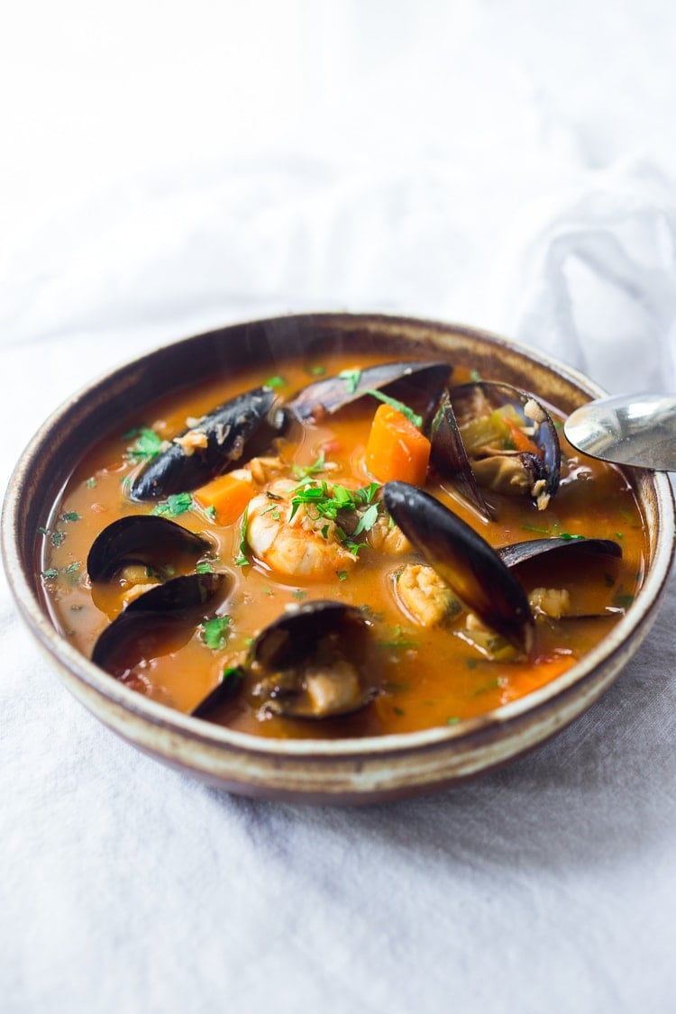 This Cioppino recipe is easy to make and full of rich flavor! Fresh fish and seafood is bathed in a light, fragrant tomato broth. Video.