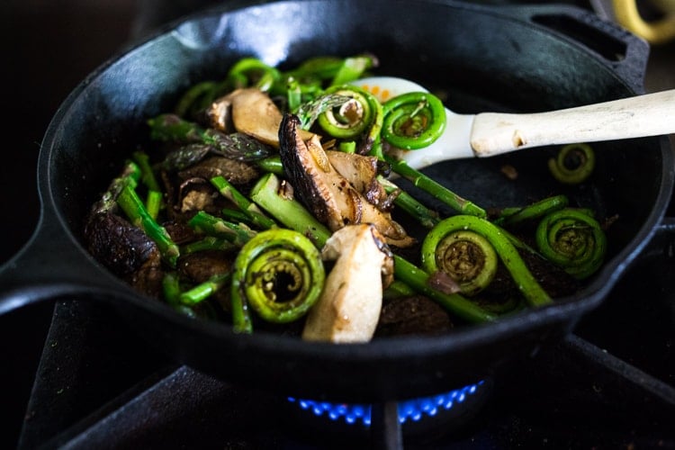 sautéing fiddlehead ferns and wild mushrooms 