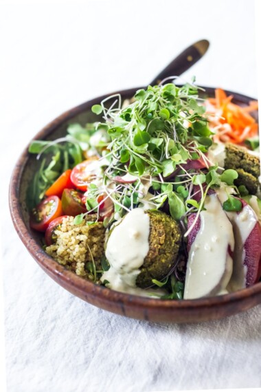 These Mediterranean Falafel Bowls are the best! Made your choice of grain, lots of healthy veggies and drizzled with tahini sauce- the falafels can be prepped ahead for the busy workweek. Vegan and Gluten-free! 