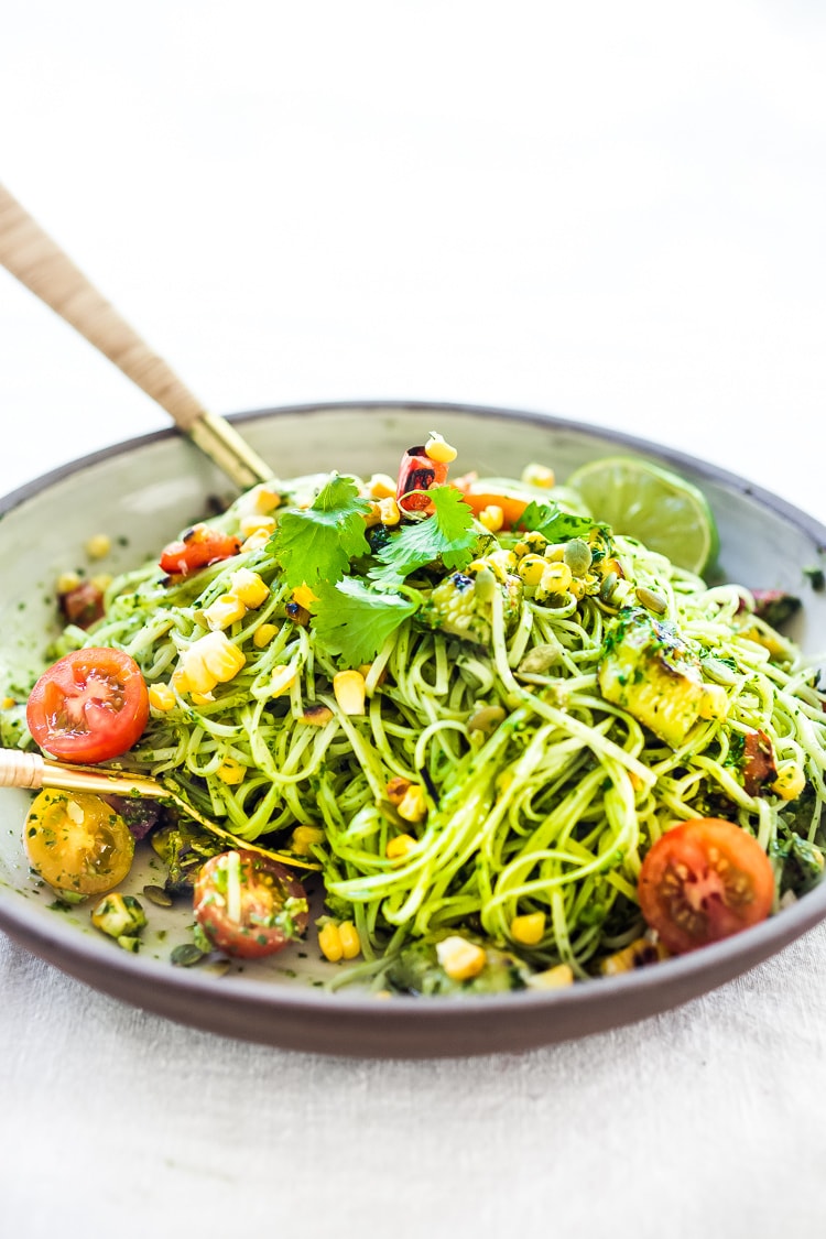 This Corn and Zucchini Pasta Salad is made with gluten-free rice noodles and loaded up with grilled summer veggies, then tossed in the most flavorful Cilantro Pesto.... deliciously addicting! Vegan and Gluten-free! #summerpastasalad #pastasalad #cornpasta #cilantropesto #zucchinipasta #zucchini #potluck