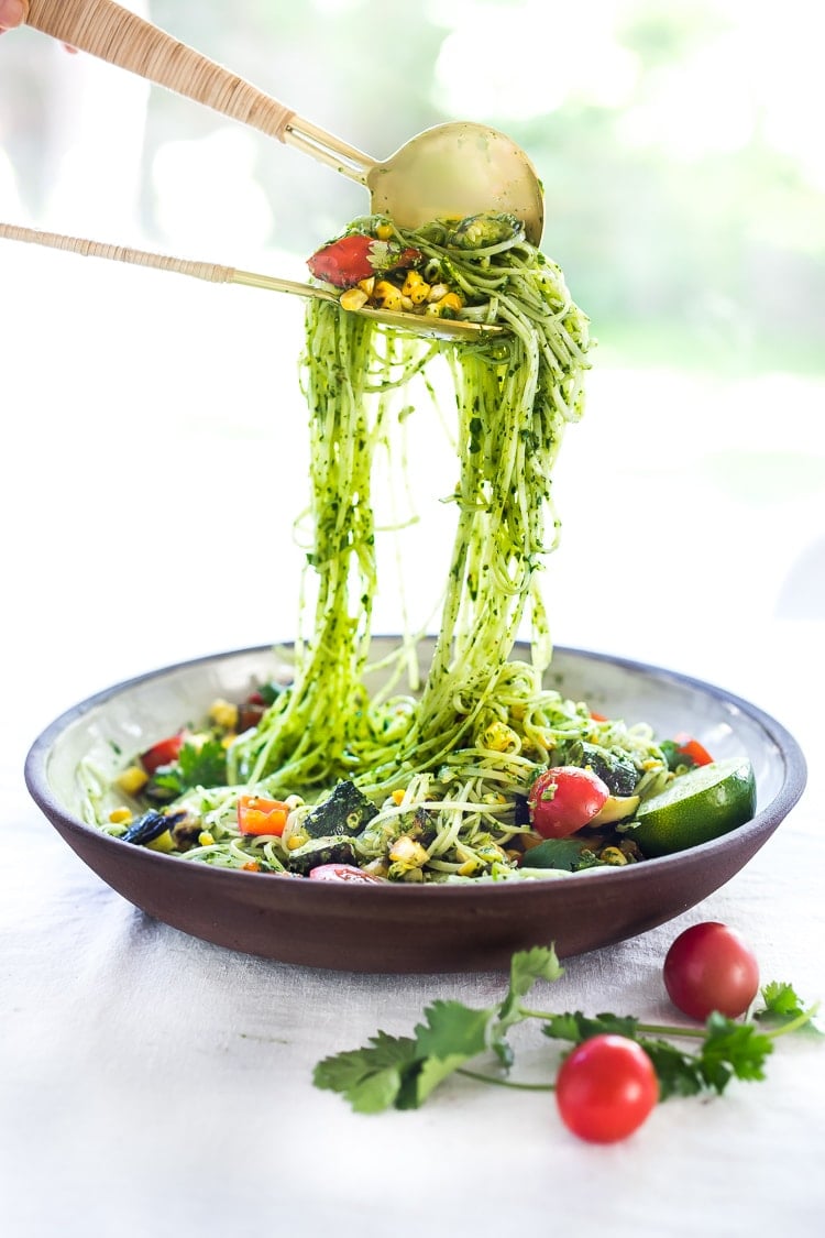 This Corn and Zucchini Pasta Salad is made with gluten-free rice noodles and loaded up with grilled summer veggies, then tossed in the most flavorful Cilantro Pesto.... deliciously addicting! Vegan and Gluten-free! #summerpastasalad #pastasalad #cornpasta #cilantropesto #zucchinipasta #zucchini #potluck