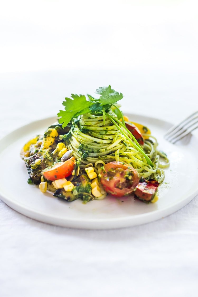 This Corn and Zucchini Pasta Salad is made with gluten-free rice noodles and loaded up with grilled summer veggies, then tossed in the most flavorful Cilantro Pesto.... deliciously addicting! Vegan and Gluten-free! #summerpastasalad #pastasalad #cornpasta #cilantropesto #zucchinipasta #zucchini #potluck