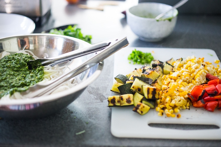 This Corn and Zucchini Pasta Salad is made with gluten-free rice noodles and loaded up with grilled summer veggies, then tossed in the most flavorful Cilantro Pesto.... deliciously addicting! Vegan and Gluten-free! #summerpastasalad #pastasalad #cornpasta #cilantropesto #zucchinipasta #zucchini #potluck