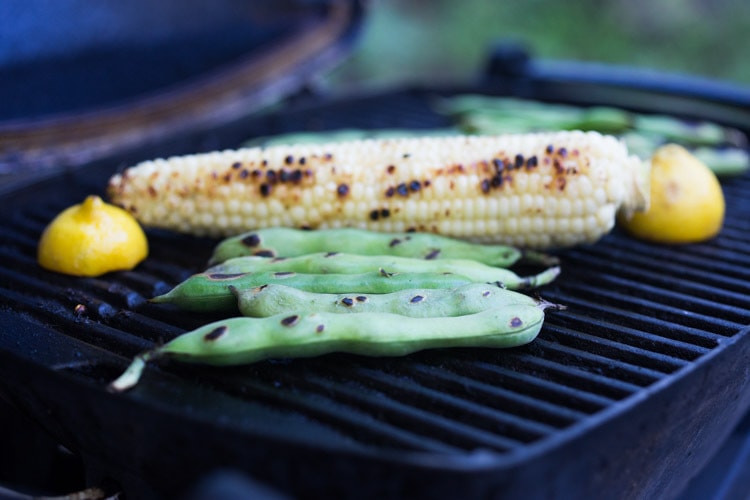 Healthy delicious, Grilled Romaine Salad with Corn, Fava Beans and Avocado - a light and refreshing summer meal. Keep it vegan or add grilled shrimp for added protein. Either way, it's sure to be your new favorite salad. Don't have access to fresh Fava beans? No worries, sub edamame! #grilledromaine #salad #romaine #fava #avocado #grilled #vegan 