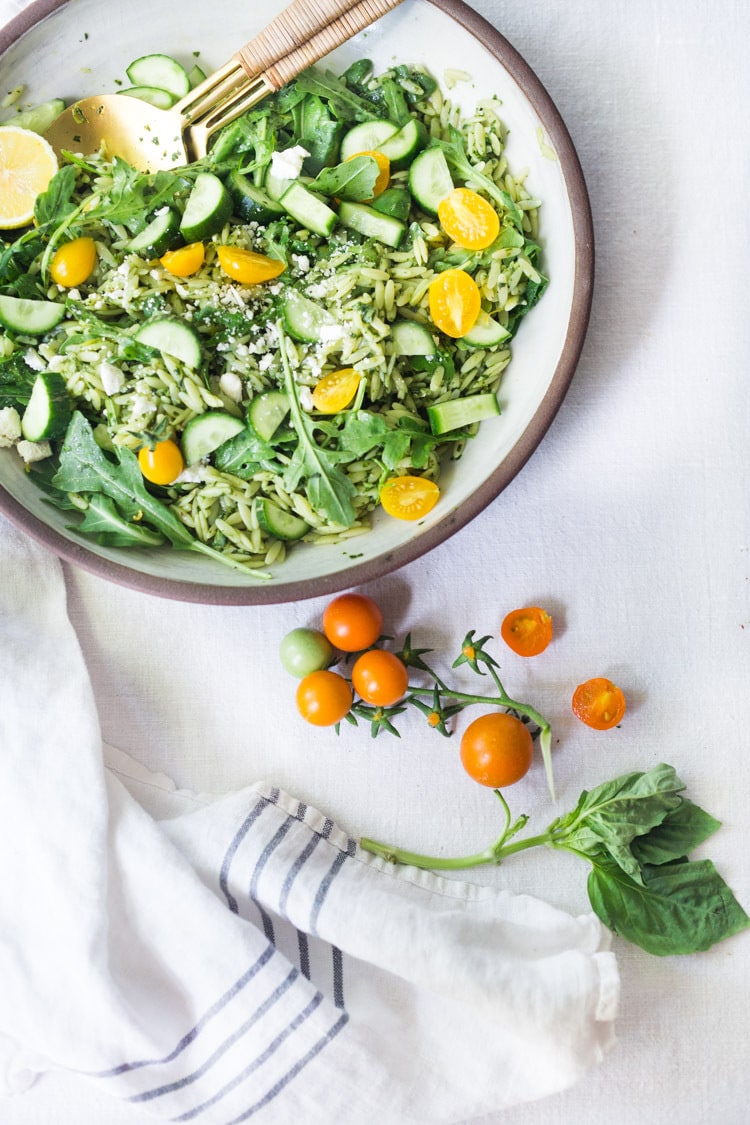 Lemon Basil Orzo Salad with cucumbers, tomatoes and arugula. A healthy, vegan pasta salad that can be made ahead for midweek lunches or potlucks. Keep it vegan or add feta! #orzo #orzosalad #orzopasta #pastasalad #vegan #orzorecipes