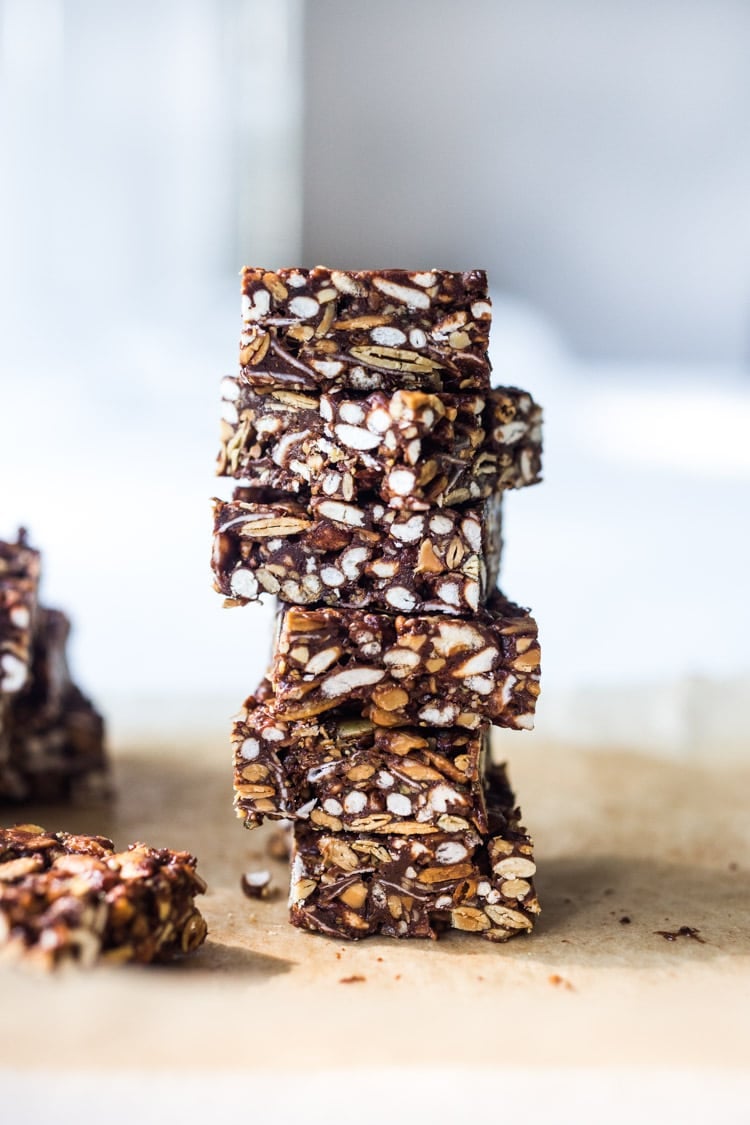 These healthy vegan Rice Crispy Treats are made with puffed 7-grain cereal, almond butter, ground cacao powder and a boatload of healthy omega 3-powered seeds- chia, sunflower and pumpkin. A delicious, VEGAN, chocolatey fix, full of nutritious ingredients.