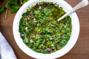 The best Chimichurri Sauce - an herby green sauce from Argentina that will quickly become your new favorite condiment. Make it in 10 minutes!