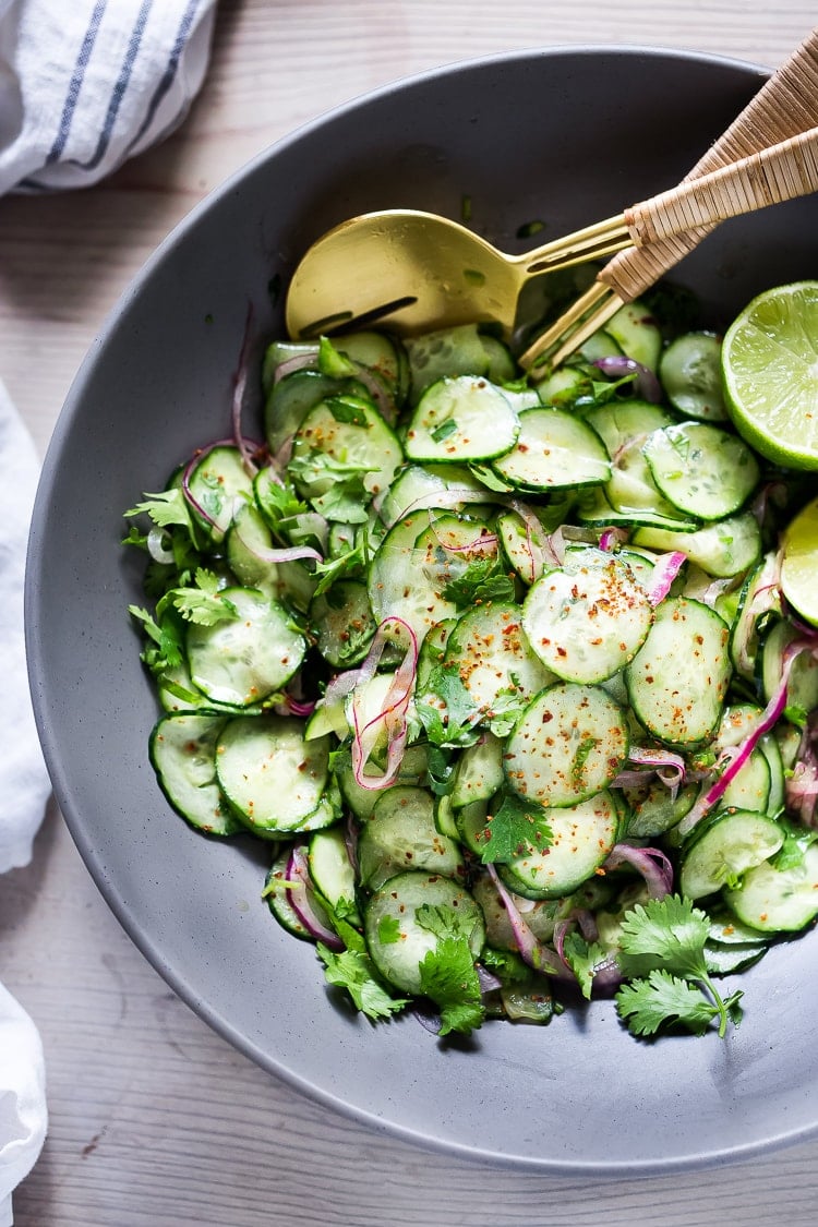 Cucumber Salad with Cilantro and Lime pairs well with so many things!  Vegan, paleo and Gluten-free! Cool and refreshing, serve it alongside grilled fish or meat. Great for Sunday meal prep! A delicious, seasonal companion to just about everything! #cucumber #cucumbersalad #potluck #mealprep #easy #healthy #batchcooking #vegan #paleo #glutenfree #lowcarb #lowcalorie 