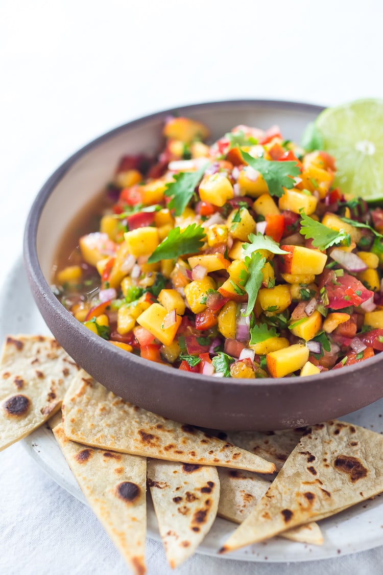 This Fresh Peach Salsa recipe is bursting with summer flavor! Delicious on its own with chips or serve over grilled fish or chicken. Simple and easy, make this when peaches are at their peak of flavor -fresh, juicy and ripe. #peachsalsa #peaches #peach #salsa #peachrecipe #peachsalsarecipe #salsarecipe