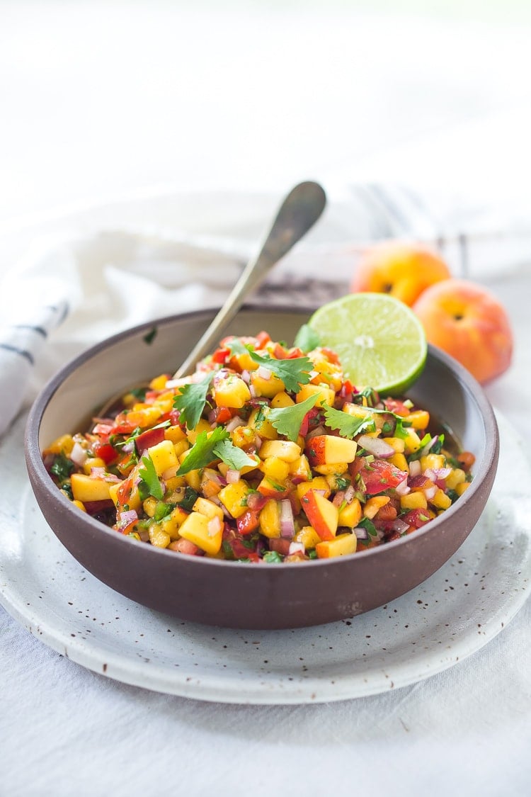 This Fresh Peach Salsa recipe is bursting with summer flavor! Delicious on its own with chips or serve over grilled fish or chicken. Simple and easy, make this when peaches are at their peak of flavor -fresh, juicy and ripe. 