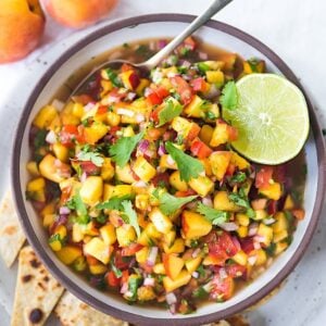 This Fresh Peach Salsa recipe is bursting with summer flavor! Delicious on its own with chips or serve over grilled fish or chicken. Simple and easy, make this when peaches are at their peak of flavor -fresh, juicy and ripe. #peachsalsa #peaches #peach #salsa #peachrecipe #peachsalsarecipe #salsarecipe