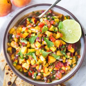 This Fresh Peach Salsa recipe is bursting with summer flavor! Delicious on its own with chips or serve over grilled fish or chicken. Simple and easy, make this when peaches are at their peak of flavor -fresh, juicy and ripe. #peachsalsa #peaches #peach #salsa #peachrecipe #peachsalsarecipe #salsarecipe