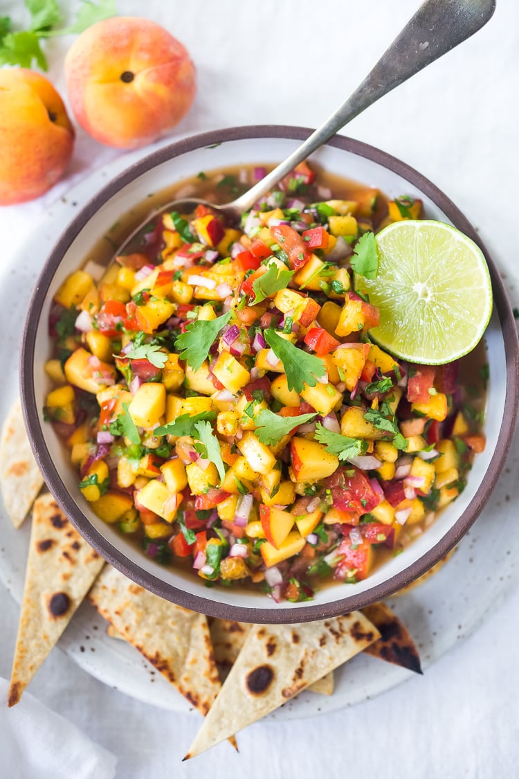 This Fresh Peach Salsa recipe is bursting with summer flavor! Delicious on its own with chips or serve over grilled fish or chicken. Simple and easy, make this when peaches are at their peak of flavor -fresh, juicy and ripe. #peachsalsa #peaches #peach #salsa #peachrecipe #peachsalsarecipe #salsarecipe