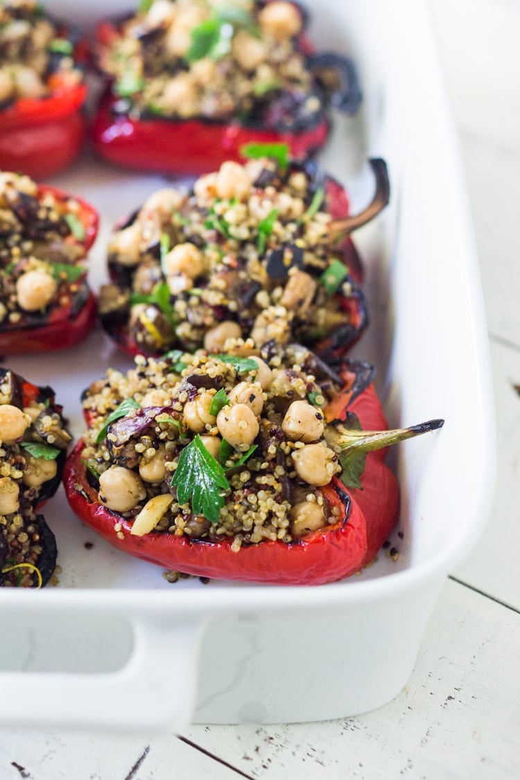 These healthy, vegetarian Stuffed Peppers with Quinoa, Eggplant, Chickpeas, Zaatar Spice and Zhoug Yogurt are the perfect make-ahead meal for summer gatherings and potlucks. Or meal prep them on Sunday to serve up during the busy workweek! Gluten free and Vegan adaptable! #stuffedpeppers | Feasting at Home