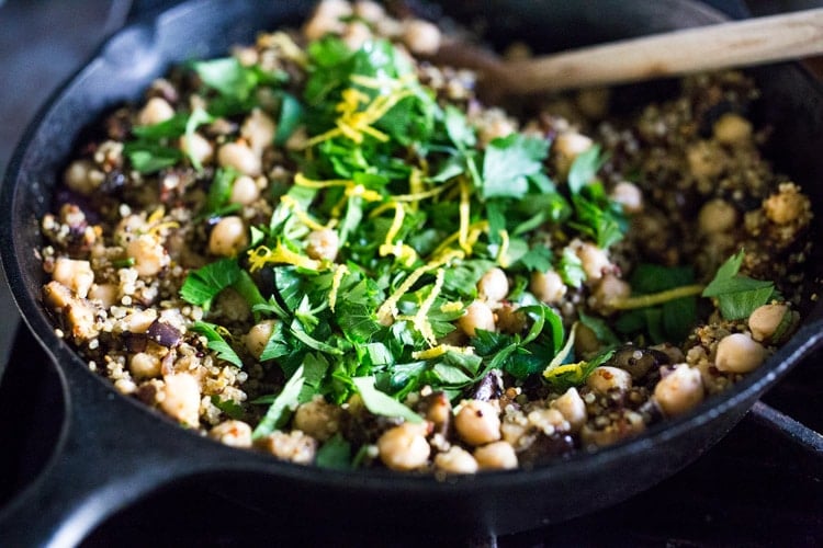 Middle Eastern Stuffed Peppers with Quinoa, Eggplant, Chickpeas and Zhoug Yogurt are the perfect make-ahead meal for summer gatherings and potlucks. Or meal prep them on Sunday to serve up during the busy workweek! Gluten-free, healthy and Vegan adaptable! #stuffedpeppers #zhoug 