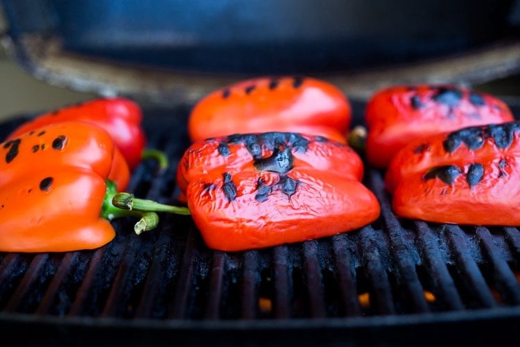 These healthy, vegetarian Stuffed Peppers with Quinoa, Eggplant, Chickpeas, Zaatar Spice and Zhoug Yogurt are the perfect make-ahead meal for summer gatherings and potlucks. Or meal prep them on Sunday to serve up during the busy workweek! Gluten free and Vegan adaptable! #stuffedpeppers | Feasting at Home