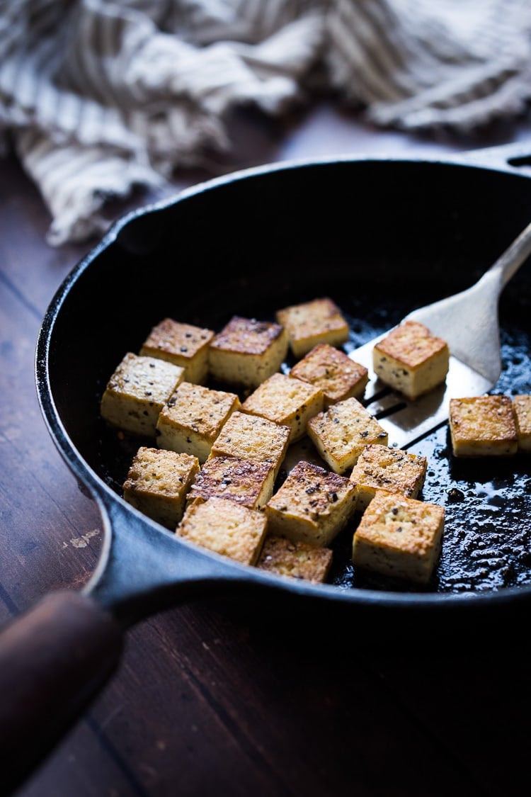 Here's a simple easy recipe for Crispy Tofu that can be made on the stovetop in 20 minutes with just 3 ingredients. You'll find a million uses for this crispy tofu and fun ways to season it - adding it to meals you are already making. #crispytofu #simpletofurecipes #easytofu #tofu #tofurecipes #friedtofu #stirfriedtofu