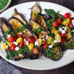 Grilled Eggplant Steaks with Fresh Tomato Relish and an Italian herb sauce called Gremolata. Keep it vegan or add crumbled cheese. A simple, healthy dinner recipe! #eggplant Feastingathome #grilledeggplant #gremolata #eggplantrecipes #eggplantsteaks #healthydinner #meatlessdinner #vegan