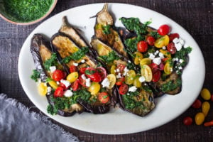 Grilled Eggplant Steaks with Fresh Tomato Relish and an Italian herb sauce called Gremolata. Keep it vegan or add crumbled cheese. A simple, healthy dinner recipe! #eggplant Feastingathome #grilledeggplant #gremolata #eggplantrecipes #eggplantsteaks #healthydinner #meatlessdinner #vegan