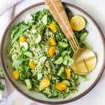 This Orzo Salad is tossed with a lemon basil dressing, with fresh cucumbers, tomatoes and arugula. A healthy, vegan, pasta salad that can be made ahead for midweek lunches or potlucks. Keep it vegan or add feta! 