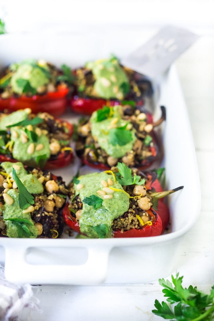 These healthy, vegetarian Stuffed Peppers with Quinoa, Eggplant, Chickpeas, Zaatar Spice and Zhoug Yogurt are the perfect make-ahead meal for summer gatherings and potlucks. Or meal prep them on Sunday to serve up during the busy workweek! Gluten free and Vegan adaptable! #stuffedpeppers | Feasting at Home 